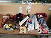 Overview image of various NASCAR branded memorabilia including bag, towels, posters, gloves, mugs, and lunch box