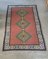 Full view of carpet laid flat on floor showing overall design and shape