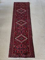 Full-length view of red wool runner laid flat