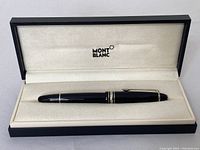 Pen in Montblanc presentation box with cream interior and black exterior, Montblanc logo inside lid.