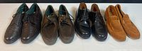 Four pairs of men's shoes in a row: black wingtip brogues, olive green casual lace-ups, black dress lace-ups, tan suede moccasins.
