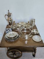 Full lot on wooden cart showing all silverplate items