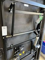 Photo of the black metal adjustable bed frame underside showing the mechanical lifting components and motor.