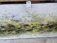 Front of artwork showing abstract green and black print on white board with lot label attached