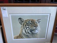 Full view of framed Robert Bateman tiger print with label showing artwork dimensions of 25 x 22 inches.