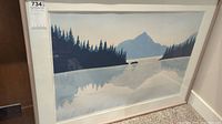 Front view of framed artwork showing mountain lake landscape with pine trees and boats