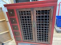 Front view of the cabinet showing five drawers on left and lattice doors on right.