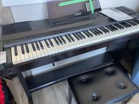 Full view of digital piano and adjustable bench