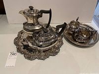 Electroplated silver tea service and trays by Sheffield displayed on a white surface with multiple items visible.