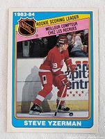 Front side of the 1983-84 Steve Yzerman rookie scoring leader hockey card showing player image and rookie scoring leader banner.