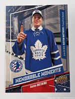 Front of 2017 Upper Deck Auston Matthews rookie hockey card with player image and team logos.