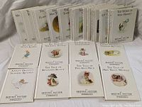 Front view of the full set of 23 Beatrix Potter books showing front covers with illustrations and titles.