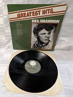 Overall photo of the vinyl LP record with the cover, showing Del Shannon's photo and song list on the front cover, and the black vinyl disc with label visible.