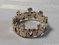 Sterling silver circle of friends ring showing inner 925 hallmark and cutout friend figures detail.