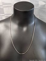 Front view of the sterling silver rope necklace displayed on a black mannequin bust showing full 24 inch length.