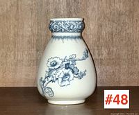 Front and angled views of the Doulton Burslem transferware toothbrush holder showing blue floral design and scrollwork at neck.