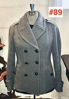 Front full view showing double-breasted button layout, lapels, and welt pockets