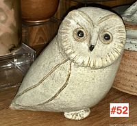 Front view of the signed Canadian studio art pottery owl, showing the detailed incised feather lines, dark eyes, and overall shape.
