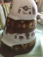 Stacked view of all four bowls showing exterior patterns and size gradation.