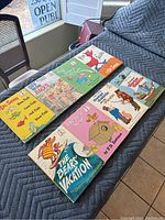 Group image showing eight Dr. Seuss beginner books arranged on a gray padded surface including 'Fox in Socks' and 'The Bear's Vacation'