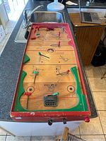 Full view of the Munro Games 1950s hockey tabletop game showing playfield, rods, and goals.