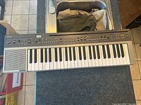 Full view of Yamaha PC-1000 keyboard showing keys, speaker, and control panel.