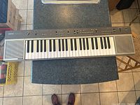 Top-down view of the full Yamaha PS-35 keyboard on a countertop showing keys, speakers, control panel