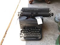 Front view of vintage black LC Smith & Corona typewriter showing keyboard and surfaced wear.