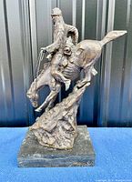 Front view of the bronze sculpture mounted on marble base