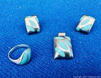 Front view of ring, pendant, and earrings showing sterling silver with turquoise inlay design