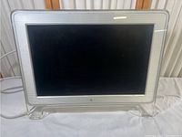 Front view of Apple Cinema HD Display monitor with 23-inch screen and acrylic stand.