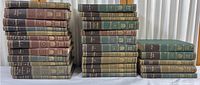 Full set of Britannica Great Books collection volumes, 28 total, arranged in groups of stacks on a white cloth background.