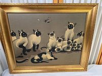 Overall front view of the framed print showing multiple Siamese cats and a butterfly