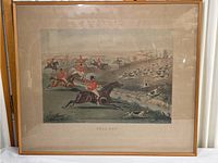Full view of the framed vintage print showing a fox hunting scene with riders in red coats, horses, and hunting dogs.