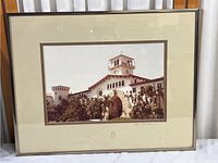 Framed photographic print showing the entire lot with building and matting visible