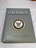 Front cover of the hardcover book, showing the U.S. Navy emblem and title.