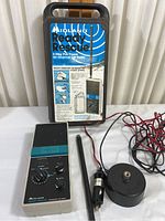 Midland Ready Rescue 2-Way CB Radio with accessories including antenna, wiring, microphone, and the original carrying case.