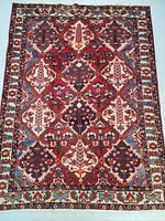 Full view of Persian Bakhtiar wool rug with geometric panel design and decorative borders.