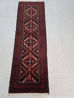 Full top view of the Persian Balouch wool runner rug showing diamond medallion pattern and multiple decorative borders.