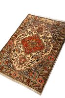 Full view of the Tabriz rug showing central medallion and floral patterns with fringed edges.