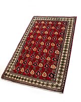 Full view of the Persian Tabriz rug showing red floral design and beige geometric bordered pattern