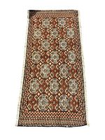 Full view of rectangular Turkmen wool rug with geometric pattern, showing the intricate repeating diamond and star motifs in natural colors.