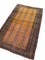 Full view of the aged Turkmen rug showing the yellow central field with geometric patterns and dark borders, laid flat to display overall condition and colors.