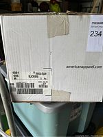 Factory sealed white cardboard box labeled with American Apparel branding and details showing quantity, size, color.