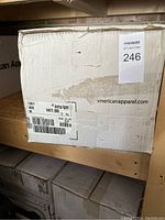 Factory sealed box with American Apparel branding and label showing 72 pieces of white medium T-shirts.