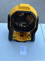 Front view of DeWALT jobsite fan showing battery slot and power button.