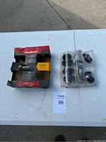 Overview of the Kwikset combo pack box with a deadbolt and door knob laid out on a white table.