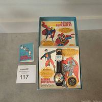 Full lot including Fossil Superman watch, collector’s coin, original packaging with comic artwork, and informational card.