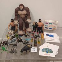 Full view of lot showing Big Foot, two GI Joe figures, A-Team BA Baracus figure, multiple insects and animals figurines, and animal flash cards.
