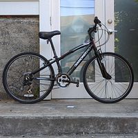 Full side profile of the black Diamondback Insight 24 boys bike showing frame and tires.